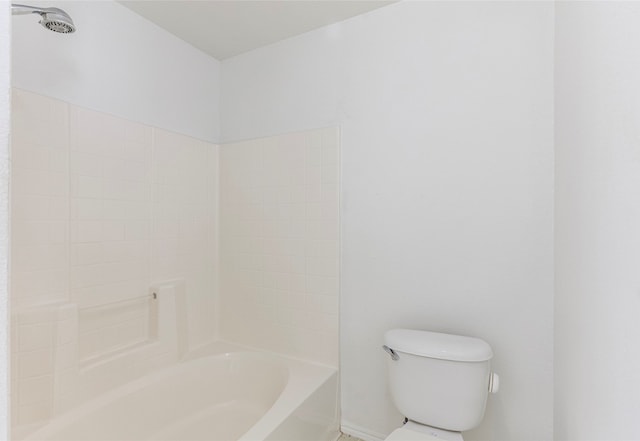 bathroom featuring shower / bathing tub combination and toilet