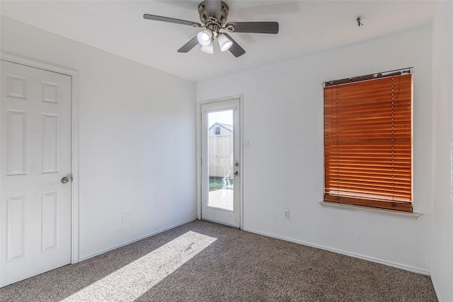 carpeted spare room with ceiling fan