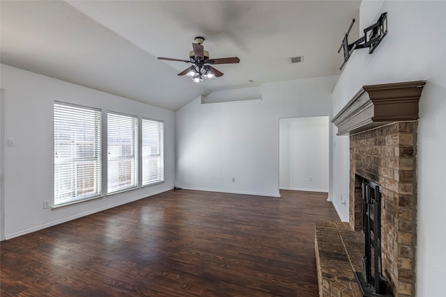 unfurnished living room featuring dark hardwood / wood-style flooring, ceiling fan, a fireplace, and vaulted ceiling