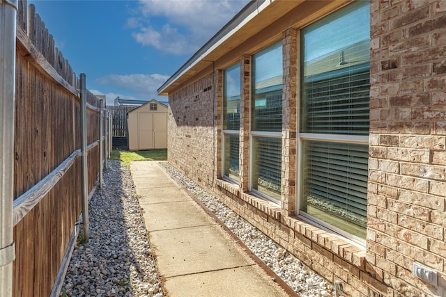 view of side of home with a storage unit