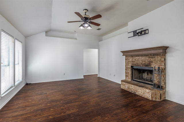 unfurnished living room with plenty of natural light, a fireplace, lofted ceiling, and dark wood-type flooring