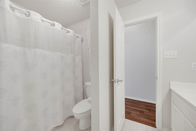 bathroom with hardwood / wood-style floors, vanity, and toilet