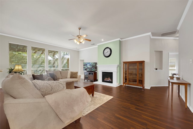 living room featuring dark hardwood / wood-style floors, ceiling fan, and ornamental molding