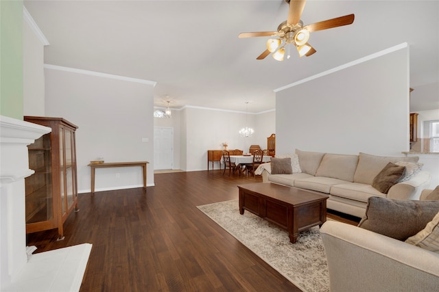 living room featuring ceiling fan with notable chandelier, crown molding, and dark wood-type flooring