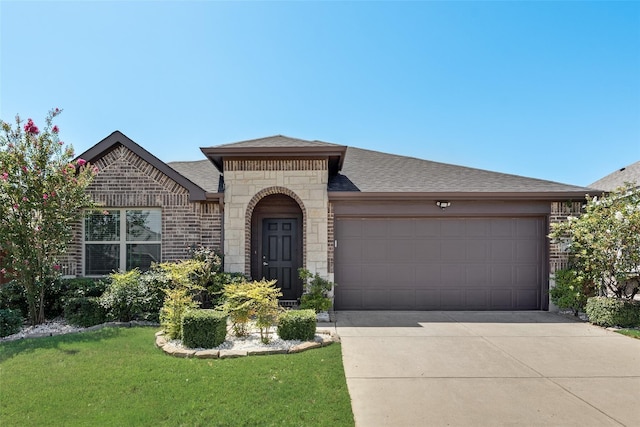 view of front of property with a garage and a front lawn