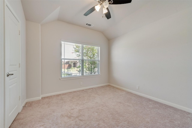 spare room with ceiling fan, light colored carpet, and lofted ceiling