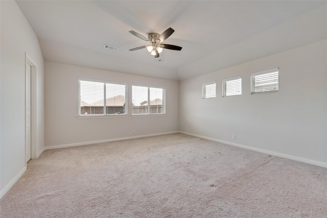 empty room with ceiling fan and light carpet