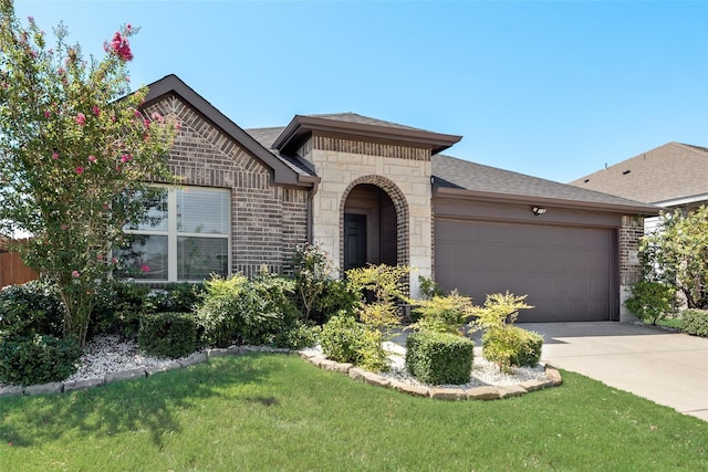 single story home with a front yard and a garage