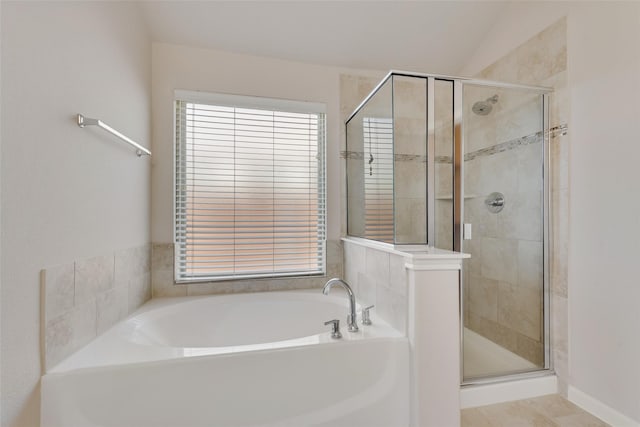 bathroom with tile patterned floors and separate shower and tub