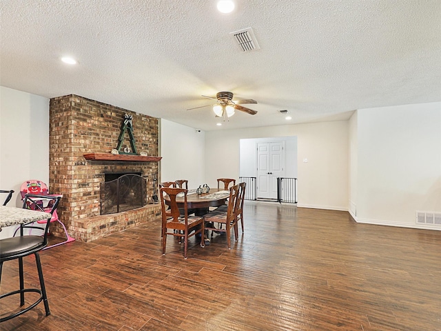 305 Dena, Krugerville, TX 76227 - dining room with a ceiling fan, wood finished floors, a textured ceiling, a fireplace, and recessed lighting
