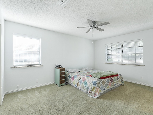 305 Dena, Krugerville, TX 76227 - carpeted bedroom featuring baseboards, a textured ceiling, and ceiling fan