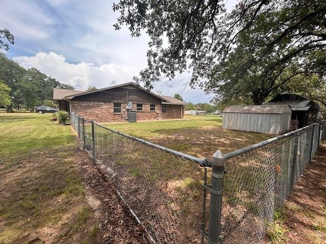 305 Dena, Krugerville, TX 76227 - view of side of home with an outdoor structure and brick siding