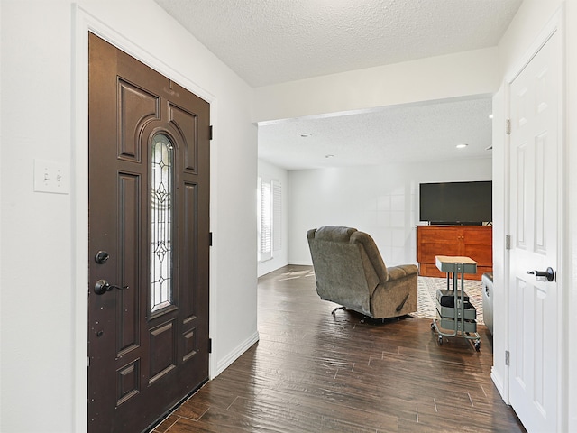 entryway with dark hardwood / wood-style flooring and a textured ceiling