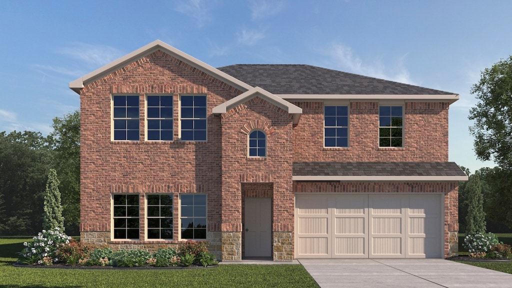 view of front of home with a front lawn and a garage