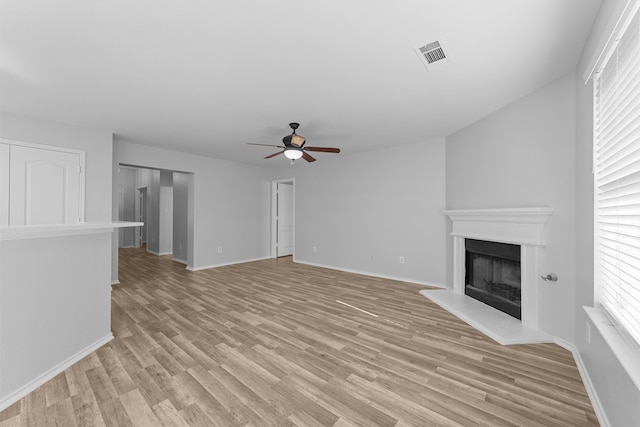 unfurnished living room with ceiling fan and light hardwood / wood-style floors