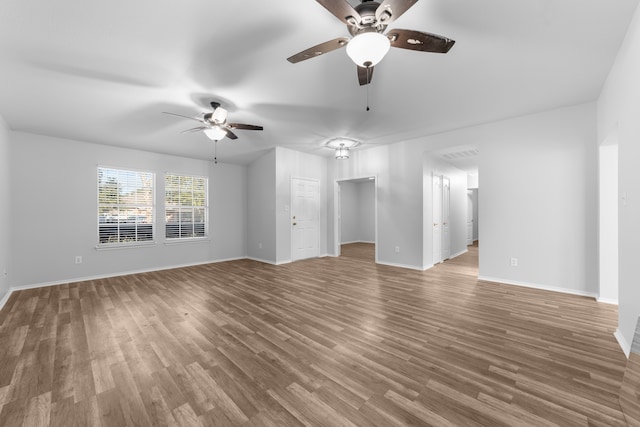 unfurnished living room with wood-type flooring and ceiling fan