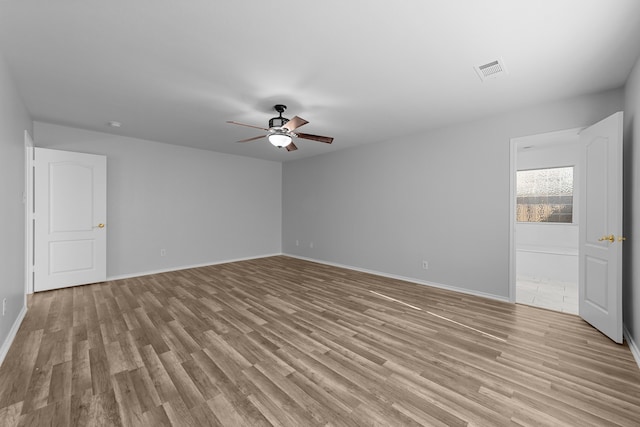 spare room with ceiling fan and light hardwood / wood-style floors