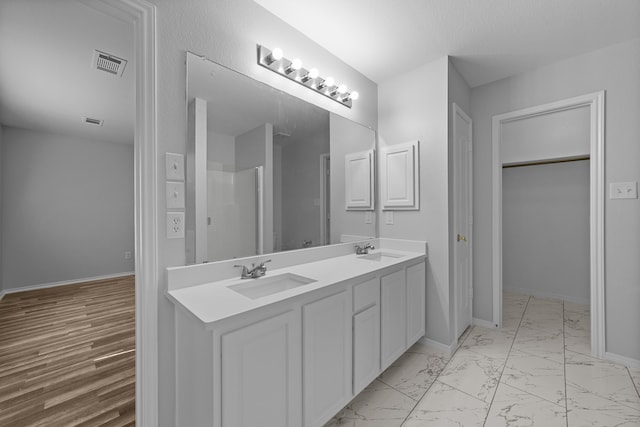 bathroom featuring vanity and hardwood / wood-style flooring