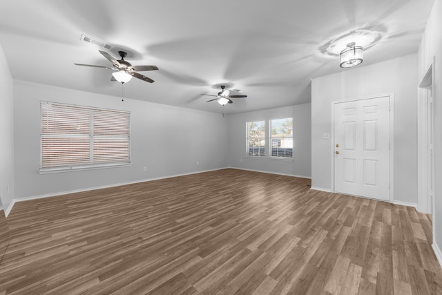 interior space with ceiling fan and dark hardwood / wood-style flooring