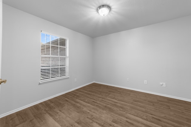 spare room with hardwood / wood-style floors