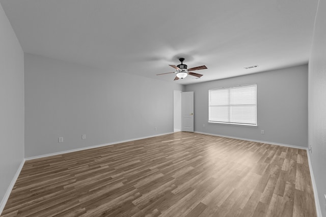 unfurnished room with wood-type flooring and ceiling fan