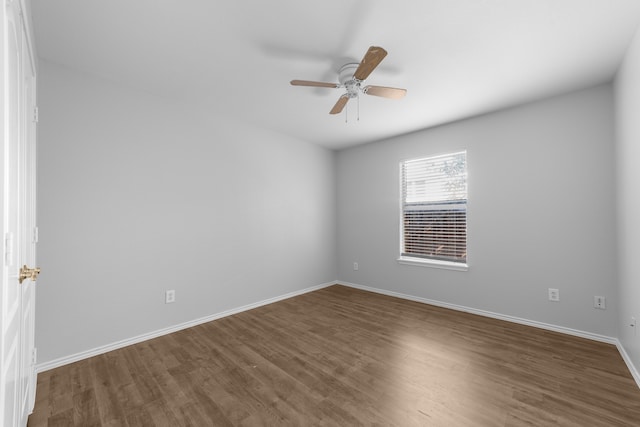 empty room featuring ceiling fan and dark wood-type flooring