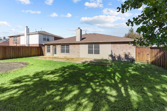 back of house featuring a yard