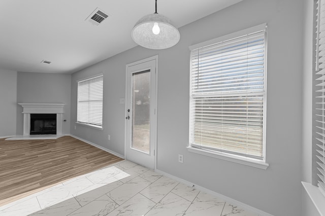 unfurnished living room featuring light wood-type flooring