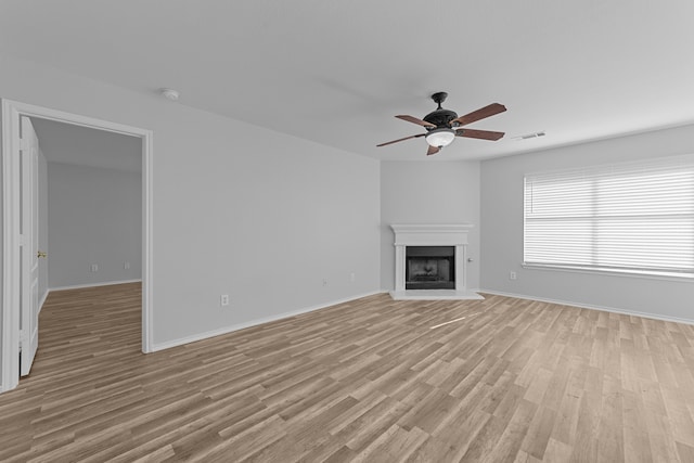 unfurnished living room with light hardwood / wood-style flooring and ceiling fan