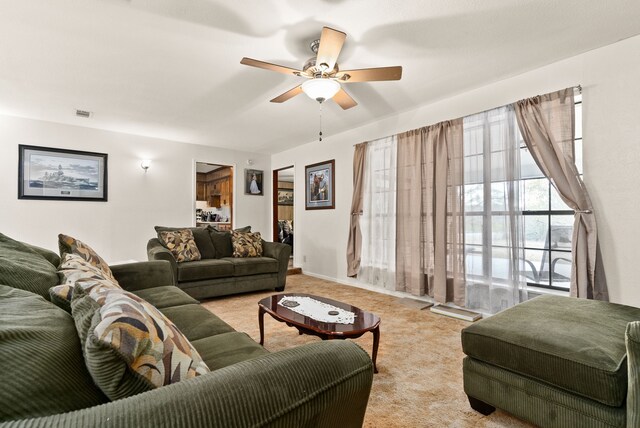 living room with ceiling fan and light colored carpet