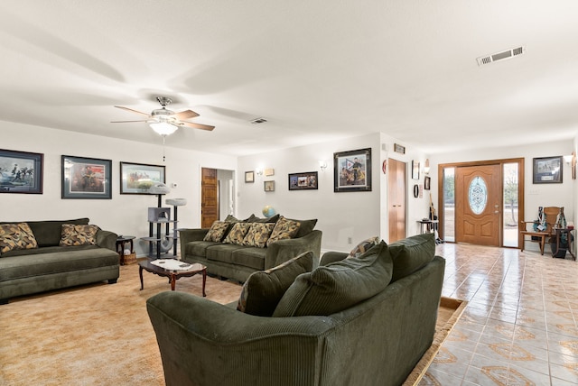 living room featuring light tile patterned floors and ceiling fan