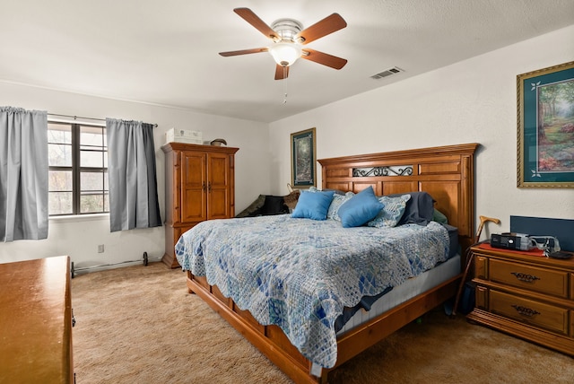 bedroom with ceiling fan and carpet floors