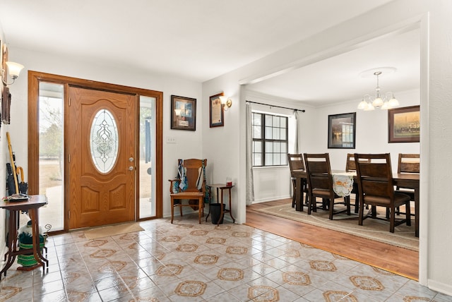 entrance foyer featuring a notable chandelier and light hardwood / wood-style flooring