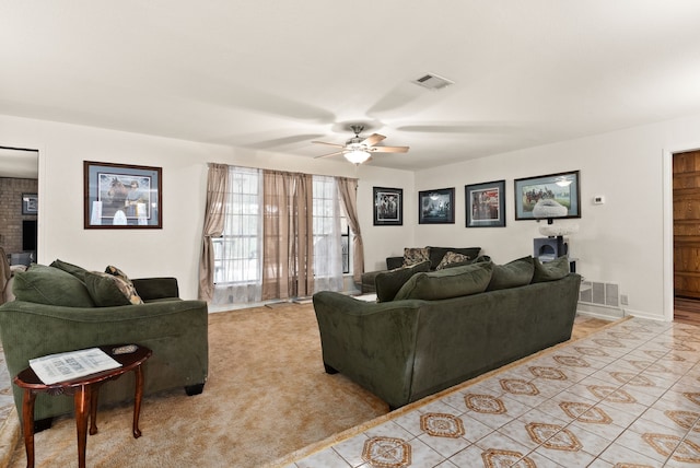 carpeted living room with ceiling fan