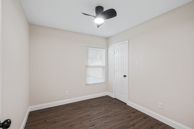 spare room featuring ceiling fan and dark wood-type flooring