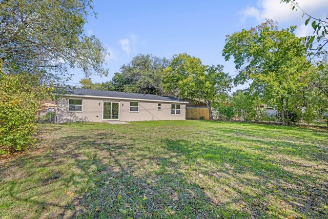 back of house featuring a yard