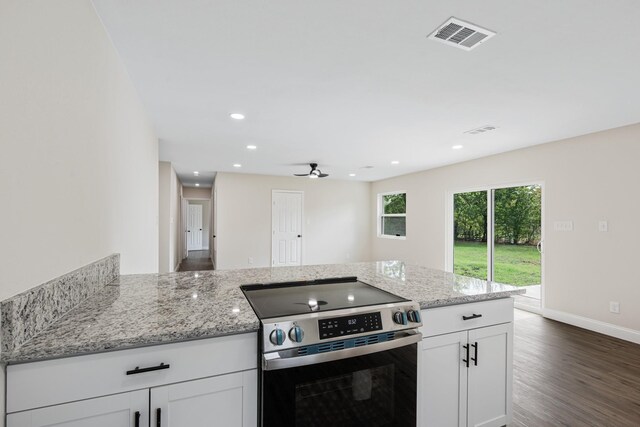 kitchen with ceiling fan, white cabinetry, dark hardwood / wood-style flooring, and stainless steel electric range oven