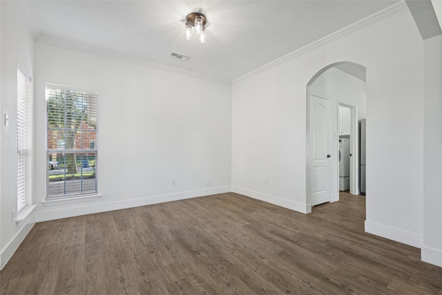 unfurnished room with dark hardwood / wood-style flooring, washer / clothes dryer, and crown molding