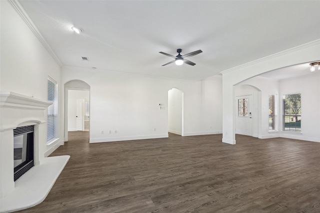 unfurnished living room featuring ceiling fan, dark hardwood / wood-style flooring, and crown molding