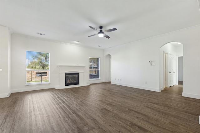 unfurnished living room with dark hardwood / wood-style floors, ceiling fan, and crown molding