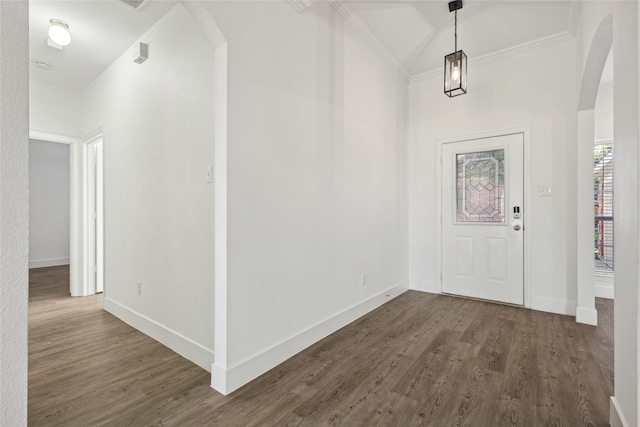 entryway with dark hardwood / wood-style floors and ornamental molding