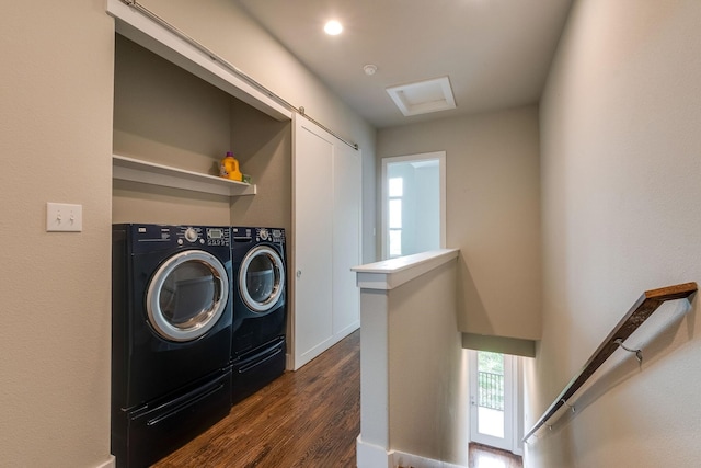 laundry area with dark hardwood / wood-style flooring and washer and clothes dryer