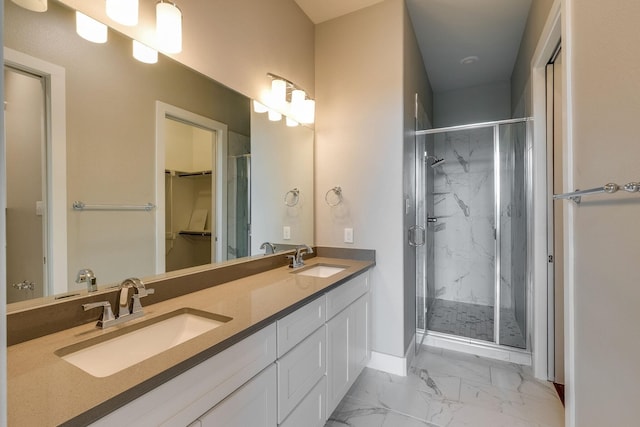 bathroom with vanity and a shower with door