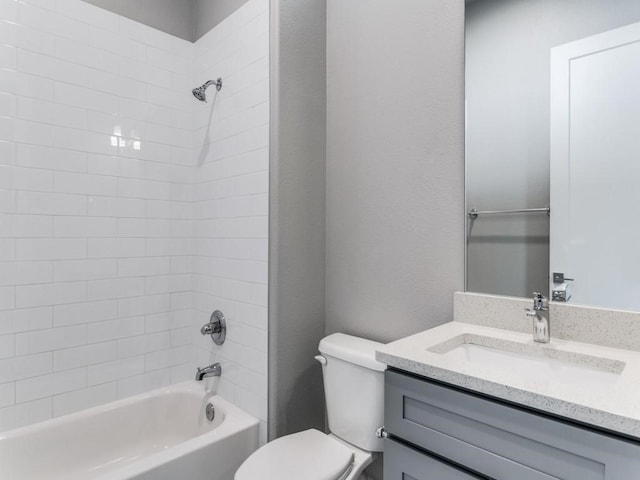 full bathroom with vanity, toilet, and tiled shower / bath