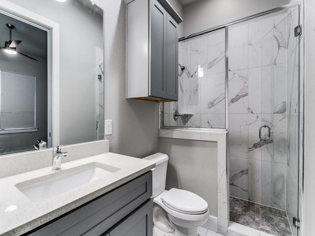 bathroom featuring ceiling fan, toilet, an enclosed shower, and vanity