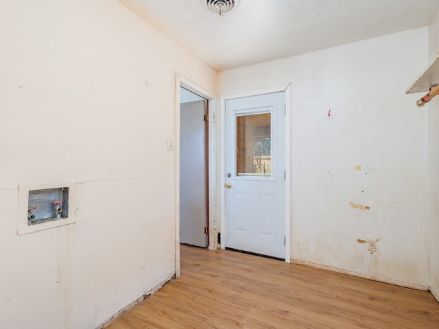 clothes washing area featuring washer hookup and light hardwood / wood-style floors