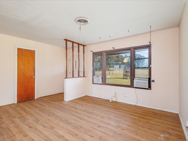 spare room featuring light hardwood / wood-style flooring and cooling unit