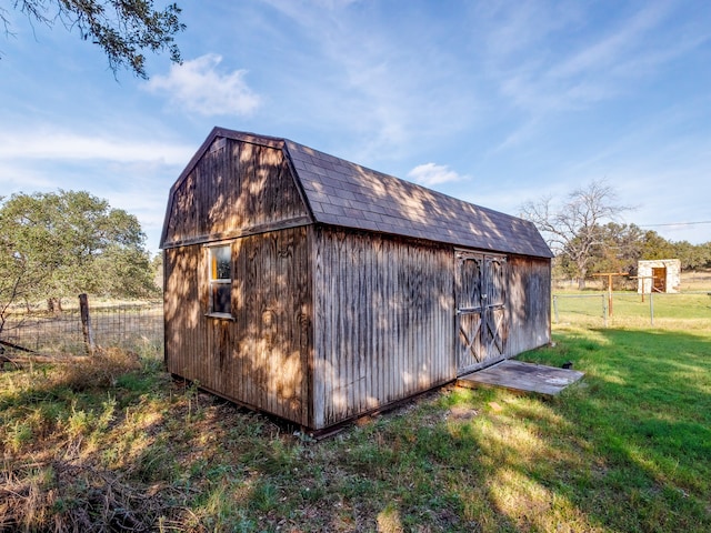 view of outbuilding with a yard