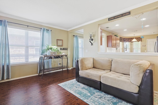 living room with crown molding, dark hardwood / wood-style flooring, and a healthy amount of sunlight