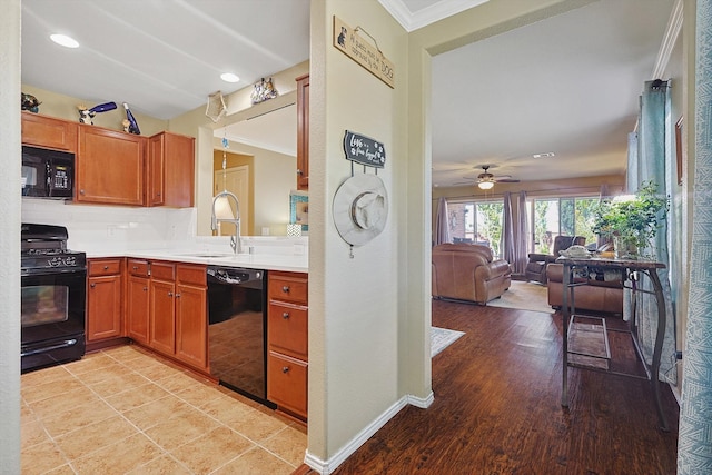 kitchen with ceiling fan, sink, crown molding, light hardwood / wood-style floors, and black appliances